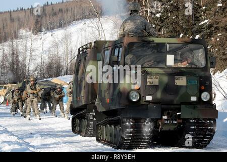 Soldaten skijour hinter einer kleinen Einheit Unterstützung Fahrzeug als Teil der US-Armee Alaska Winter Spiele am Fort Wainwright, Alaska, 9. März 2017. Veranstaltungen in diesem Jahr gehören Downhill Ski Racing, live-fire biathlon Range, Stress schießen, land Navigation, Skijöring, Einrichten der Arktis 10-Mann Zelt und Herd richtig, und die Bewertung und Behandlung von einem Unfall in der extremen Kälte. Als Amerika's Arctic Krieger und Experten der US-Armee in Überlebenden, Betrieb, kämpfen und gewinnen in extrem kalten Wetter und Höhenlage Umgebungen, alle Fertigkeiten, die während der Spiele getestet sind kritisch für alle USARAK S Stockfoto