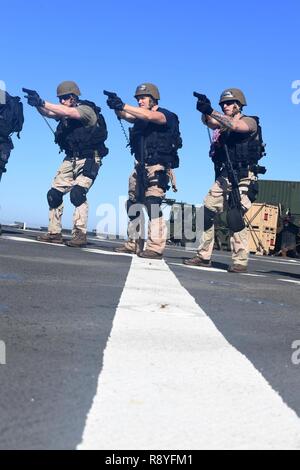 Mittelmeer (10. März 2017), Ensign Richard A. Descano, Links, Operations Specialist 3. Klasse Andrew S. Wiggers, Mitte und Rumpf Wartungstechniker in der 2. Klasse Tom K. Hodge, rechts, in verbesserte Treffsicherheit Bohrer teilnehmen, während in der Nähe viertel Schlacht Training auf dem Flugdeck an Bord der Amphibischen dock Landung Schiff USS Carter Hall (LSD 50). Das Schiff ist mit der bataan Amphibious Ready Gruppe implementiert Maritime Security Operations und Theater Sicherheit Zusammenarbeit in den USA 6 Flotte Bereich der Aktivitäten zu unterstützen. Stockfoto