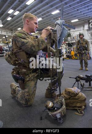 EAST CHINA SEA (17. März 2017) Staff Sgt. Matthäus Tippett, aus Trenton, New Jersey, zugeordnet zu den 31 Marine Expeditionary Unit (MEU), führt der vorbeugende Brandschutz Kontrollen auf einer M110 semi-automatischen Sniper System im Hangar Bucht von Amphibisches Schiff USS BONHOMME RICHARD (LHD6) als Teil der amphibischen Integration Training (AIT). AIT ist so ausgelegt, dass alle Elemente der Bonhomme Richard Expeditionary Strike Group (BHR ESG) und die 31. MEU ihre Fähigkeit zur Planung und Mission wesentliche Aufgaben ausführen, um Test zu integrieren. Bonhomme Richard, dem Flaggschiff der BHR ESG, mit Eingeschifft 31 MEU, ist auf eine Routine pat Stockfoto