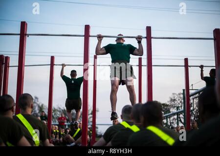 Bohrer Ausbilder mit Unterstützung Bataillon pullups März 10, 2017, zu den Rekruten, die Charlie Unternehmen zugewiesen wird, demonstrieren, 1 Recruit Training Bataillon, auf Parris Island, S.C. Die anfängliche Stärke Test wird sichergestellt, dass die rekruten die minimalen körperlichen Anforderungen erfüllen, um die Ausbildung zu beginnen. Charlie Company ist zu graduieren, 2. Juni 2017 geplant. Rund 19.000 Rekruten kommen auf Parris Island jährlich für die Chance, United States Marines werden durch dauerhafte 12 Wochen der Strenge, transformative Training. Parris Island ist die Heimat von Entry-level-Soldaten Ausbildung für rund 49 Prozent. Stockfoto