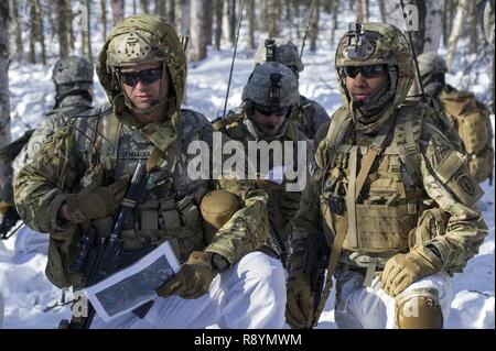 Kapitän Douglas Ausenbaugh, Links, die Firma Commander für Apache Unternehmen, 1.BATAILLON, 501 Fallschirm Infanterie Regiment, 4 Infantry Brigade Combat Team (Airborne), 25 Infanterie Division, U.S. Army Alaska, Relais Bestellungen beim Leiten der live-Fire Training am Infanteriezug Schlacht Kurs auf gemeinsamer Basis Elmendorf-Richardson, Alaska, 17. März 2017. Die Ausübung geschliffen Infanterie Fähigkeiten die Fallschirmjäger' wie Platoon Bewegung und Kommunikation, Hindernis gegen und die Erfassung objektiver durch Angriff und Manöver. Ausenbaugh ist ein Eingeborener von Indianapolis, Ind. Stockfoto