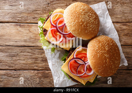 Veggie Burger mit frischem Salat, Zwiebeln, Tomaten und Cheddar Käse close-up auf dem Tisch. horizontal oben Ansicht von oben Stockfoto