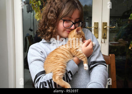 12 Jährige Mädchen mit Ingwer und weiße Katze Surrey, England Stockfoto