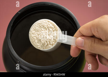 Whey Protein Pulver sport Bodybuilding Supplement. Sicht von Hand mit Schaufel messen. Vanille Aroma. Farbe: Braun. Stockfoto