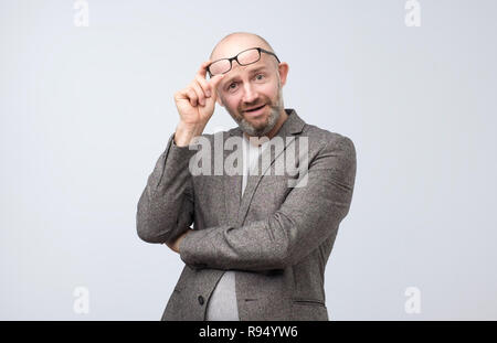 Portrait von Neugierig reifer Mann über Gläser an Kamera suchen Stockfoto