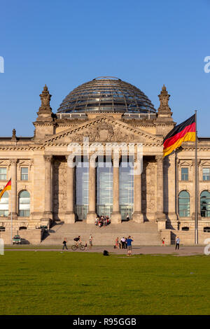 BERLIN, DEUTSCHLAND - 22. MAI 2014: Menschen auf der Wiese vor dem Reichstag, Sitz des deutschen Parlaments (Deutscher Bundestag). Stockfoto