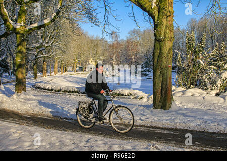 Mann, Radfahren durch verschneite Winterlandschaft mit Schnee Stockfoto