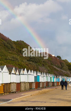 Bournemouth, Dorset, Großbritannien. Dezember 2018 20. Regenbogen über Bournemouth auf einer überwiegend sonnigen Tag, wie ein paar Gehminuten entlang der Promenade Vergangenheit Strandhütten. Credit: Carolyn Jenkins/Alamy leben Nachrichten Stockfoto