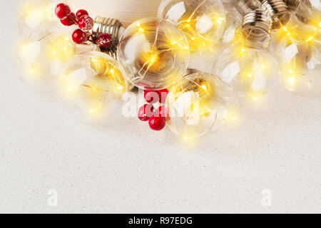 Weihnachten oder Neujahr Dekoration gelb Girlande mit Beeren auf grauem Hintergrund Stockfoto