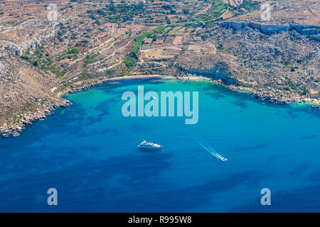 Mgiebah Bay, einsamen Bucht über einen steilen, felsigen Weg, mit einem kleinen Sandstrand und türkisblauem Wasser. Mellieha, Malta. Stockfoto