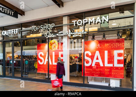 Westwood Cross Einkaufszentrum, Super Samstag. Verschwommene Frau Shopping mit großen Tragetasche, mit kaum einen Blick große rote Fenster Schilder 50% Umsatz der Topman, TopShop und Miss Selfridges re. Stockfoto