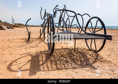 Caesarea, Israel - 22. Mai 2012: Moderne Skulpturen der römischen Pferd Wagen der Schwarz gebogen geschmiedete Metallständer auf antiken Caesarea Strand, wo lange ti gemacht Stockfoto