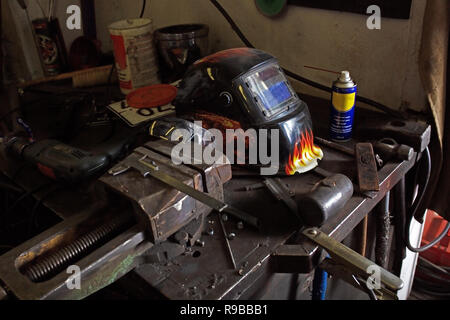 Schützende helmetand Schraubenschlüssel Werkzeuge auf einem Tisch in der Werkstatt. Industrial Szene mit Ausrüstung Stockfoto