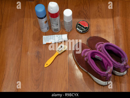 Paar Frau Wildleder Schuhe mit Reinigung, Pflege Produkte wie Sprays, Pinsel, Polnisch eingestellt. hohen Winkel von oben im Bild Stockfoto