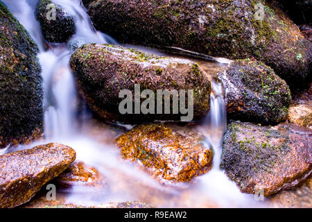 Kleiner Wasserfall zwischen Felsen Stockfoto