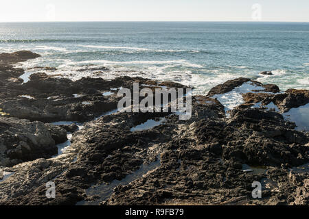 Die Wellen an den Felsen vor der Küste am Cape Perpetua Special Interest Bereich, wo Thor's gut gelegen ist, Oregon, USA Stockfoto