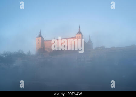 Toledo Alcazar bei Sonnenaufgang im Nebel, Castilla la Mancha, Spanien. Stockfoto