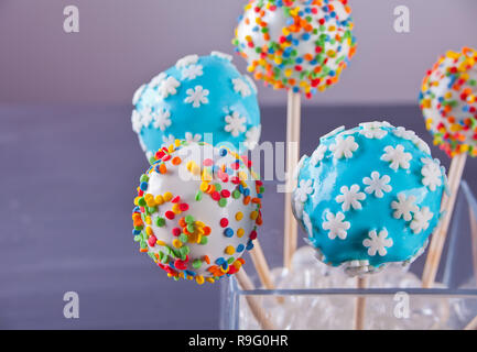 Verschiedene Kuchen Pops mit Schokolade auf einen hölzernen Tisch dekoriert Stockfoto