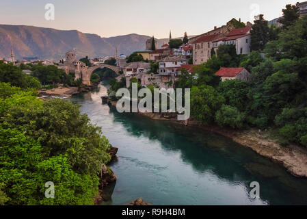 Häuser und Stari Most (Alte Brücke) entlang des Flusses Neretva, Mostar, Bosnien und Herzegowina Stockfoto