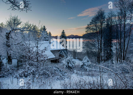 Kleines Haus im Wald im Schnee verloren Stockfoto