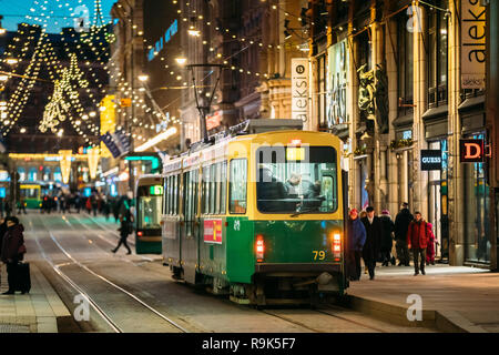 Helsinki, Finnland - 6. Dezember 2016: Straßenbahn fährt von der Haltestelle Aleksanterinkatu Straße. Nacht Abend Weihnachten neues Jahr festliche Straße Illumina Stockfoto