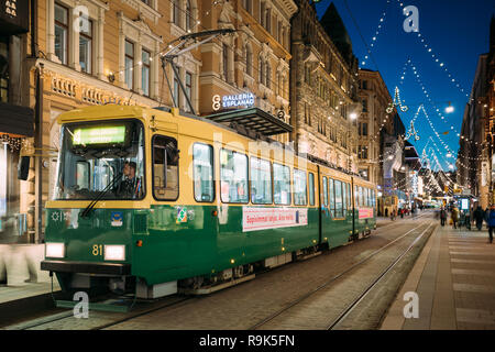 Helsinki, Finnland - 6. Dezember 2016: Straßenbahn fährt von der Haltestelle Aleksanterinkatu Straße. Nacht Abend Weihnachten neues Jahr festliche Straße Illumina Stockfoto