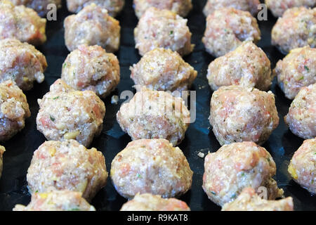 Raw Türkei Frikadellen auf einem schwarzen kochen Blatt Stockfoto