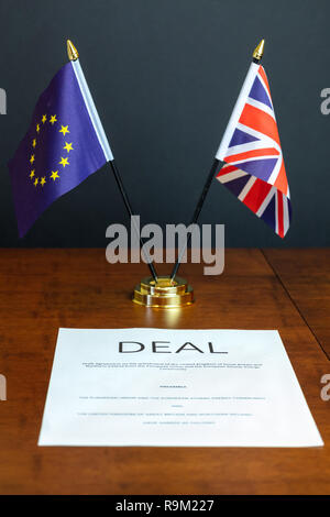 Brexit Konzept. Blatt Papier unter der Leitung 'Deal' auf einem Tisch mit Tischplatte UK- und EU-Flaggen hinter Stockfoto