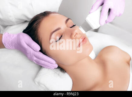 Schöne Frau mit Ultraschall, Kavitation Facial Peeling. Kosmetik und Gesichtspflege Stockfoto