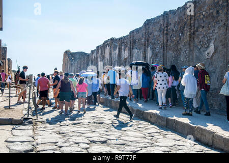 Japanische Touristen, Mützen Regenschirm Regenschirme Vordächer, Sonnenschutz Sun, Pompeji, Italien, touristische Konzept, Travel besuchen Sie erkunden erkunden heißen Tag Sonnenschirm sun Stockfoto