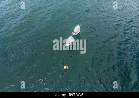 Antenne drone Foto von Teenagern auf kleine Segelboote in der Regatta im Mittelmeer smaragdgrünen Meer konkurrieren Stockfoto