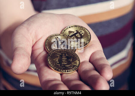 Mann hält Bitcoin btc cryptocurency Goldmünze in der Hand Stockfoto