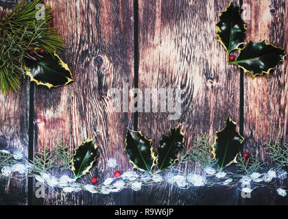 Hintergrund holly angezeigt, Holz- und Weihnachtsbeleuchtung Schuß für Kopie Raum über dem Kopf Bild ideal für Text über für Verkaufs- oder Poster legen Stockfoto