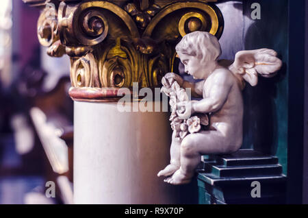 Ein Engel mittelalterliche Skulptur aus weißem Marmor auf dem Hintergrund einer vergoldeten Bildunterschrift. Foto von der Kathedrale entfernt. Stockfoto