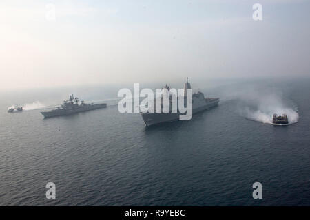 U.S. Navy Landing Craft, Luftkissen, Manöver neben der U.S. Navy San Antonio-Klasse amphibious Transport dock Schiff USS Anchorage, Mitte, und der indischen Marine Zerstörer ins Rajput, Links, während kooperative Übungen zum 26. Dezember 2018 im Indischen Ozean. Stockfoto