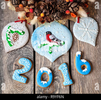 2016 Jahr von Lebkuchen und Vogel auf Weihnachten Süße Spielzeug in der Nähe von Weihnachten Girlande auf hölzernen Hintergrund Stockfoto