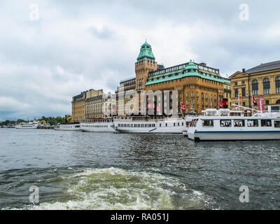 Panoramablick von der touristischen Ausflugsboot zum Pier mit Booten und die schönen Gebäude von Stockholm Schweden Stockfoto