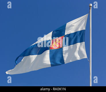 Finnische State Flag mit Wappen vor blauem Himmel Stockfoto