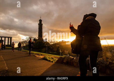 Ein paar Nehmen ein selfie wie die Sonne über Carlton Hill in Edinburgh. Stockfoto