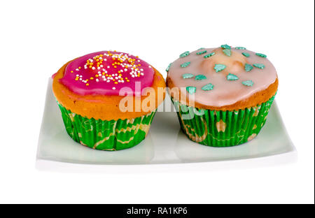 Zwei selbstgemachte mini Cupcakes mit farbiger Zuckerglasur. Studio Foto Stockfoto