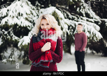 Schönes Paar im Winter Wald posing und Kamera. Stockfoto