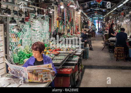 Abschaltdruck Inhaber bei Hong Kong's berühmten Jade Markt mit ihren bunten Displays von Jade Armbänder, Perlen und Schmuckstücke. Stockfoto