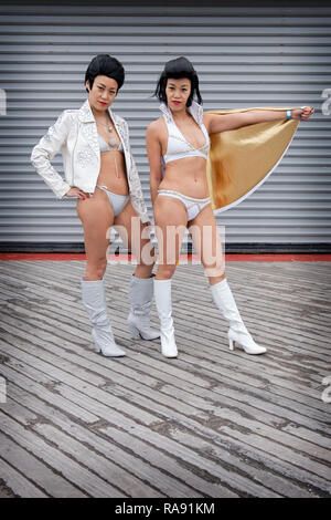 Stellen Porträt von zwei chinesischen Elvis Presley Imitatoren in Bikinis am Tag der jährlichen Polar Bear Club Das neue Jahr Schwimmen in Coney Island, Brooklyn, New York City. Stockfoto