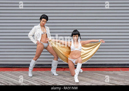 Stellen Porträt von zwei chinesischen Elvis Presley Imitatoren in Bikinis am Tag der jährlichen Polar Bear Club Das neue Jahr Schwimmen in Coney Island, Brooklyn, New York City. Stockfoto