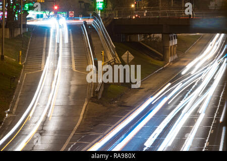 Lange Belichtung einer Autobahn Verkehr in der Nacht - leichte Wanderwege in den Schoß gemalt. Stockfoto