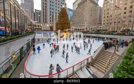 Schlittschuhläufer an der Eislaufbahn am Weihnachtsbaum am Rockefeller Center. Stockfoto