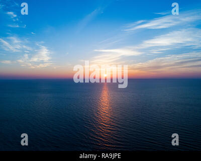 Luftaufnahme von einem Sonnenuntergang Himmel Hintergrund. Antenne dramatische gold Sonnenuntergang Himmel mit Abend Himmel Wolken über dem Meer. Atemberaubende Himmel Wolken bei Sonnenuntergang. Sky l Stockfoto