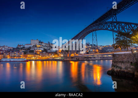 Porto, Portugal. Stadtbild Bild von Porto, Portugal mit Reflexion der Stadt in den Fluss Douro und die Luis I Brücke während der Dämmerung blaue Stunde. Stockfoto