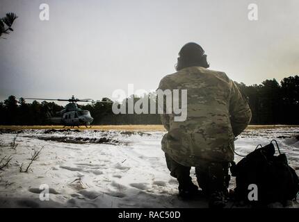 New Jersey Army National Guard Staff Sgt. Michael verbogen, ein Pfadfinder mit der 1-114 th Infanterie, kommuniziert mit dem Marine Corps Flugzeuge aus marinen Flugzeuge Gruppe 49 bei einer gemeinsamen Übung am Joint Base Mc Guire-Dix - Lakehurst, New Jersey, Jan. 10, 2017. Das Marine Corps Reserve Luftbrücke und Close Air Support zu Alpha Company Soldaten von 1-114. Die 1-114, die Teil der 50th Infantry Brigade Combat Team, beteiligt sich an einer Reihe von Schulungen, die in diesem Sommer wird an eine exportierbare Kampftraining Fähigkeit Übung auf Fort Pickett, Va. Die Armee der Nationalen Guar münden Stockfoto