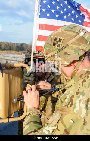 Deutsche und Polen Grenze - Soldaten der 3. Brigade Combat Team, 4 Infanterie Division in Fort Carson, Colorado, mount eine amerikanische Flagge vor einer Fahne exchange Zeremonie an der deutschen und polnischen Grenze, Jan. 12, 2017. Dieser Einsatz ist der Beginn der back-to-back Drehungen von gepanzerten Brigaden in Europa als Teil der Atlantischen lösen. Die Fahrzeuge und Ausrüstungen, in Höhe von insgesamt mehr als 2.700 Stücke, wird Polen für die Zertifizierung vor der Bereitstellung in Europa für den Einsatz in Training mit Partner Nationen geliefert werden. Diese Rotation verbessert die Abschreckung Fähigkeiten, erhöht die Fähigkeit zur Reaktion auf Po Stockfoto